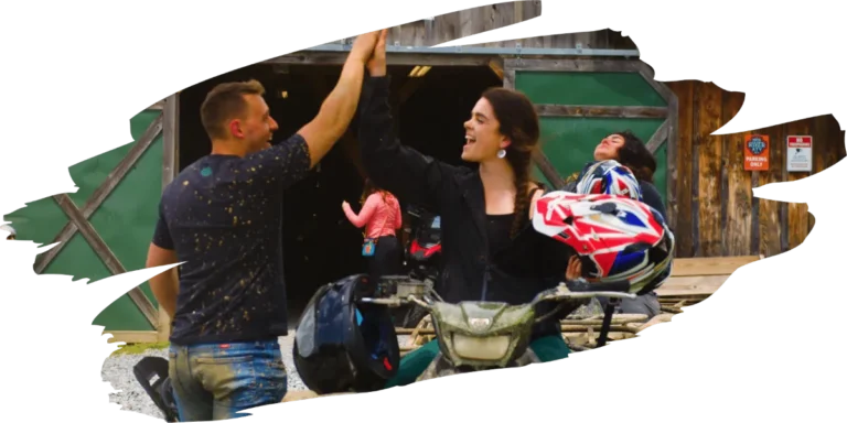 Two people high fiving on an atv tour